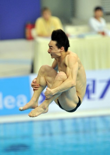 Qin Kai of China competes during the men's 3m springboard final at the FINA Diving World Series 2013 held at the Aquatics Center, in Beijing, capital of China, on March 16, 2013. Qin Kai claimed the champion with 548.65 points. (Xinhua/Li Wen) (lm)