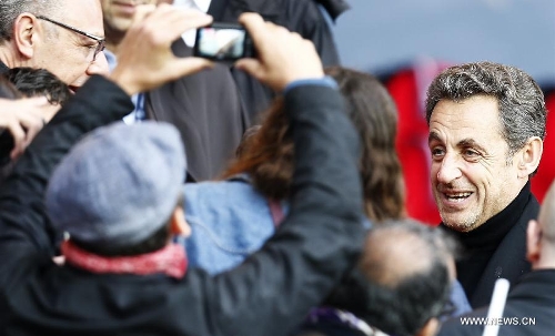 Former French President Nicolas Sarkozy (R) is seen on the stand ahead of a French League 1 football match between Paris St Germain and Brest at Parc des Princes stadium in Paris on May 18, 2013. Paris Saint-Germain won 3-1. (Xinhua/Wang Lili)