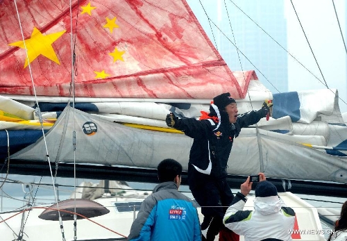 China's Guo Chuan (Top) celebrates after returning home in Qingdao, east China's Shandong Province, April 5, 2013. Guo sailed back home on Friday morning to become the first Chinese to successfully circumnavigate the globe singlehanded. Aboard his Class40 yacht, 48-year-old Guo travelled about 21,600 nautical miles in 138 days before he returned to his hometown of Qingdao, where he set off on November 18 last year. (Xinhua/Li Ziheng)