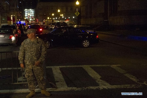 A National Guardsman stands guard in front of the scene of the explosion in Boston, the United States, April 15, 2013. The two explosions that rocked the Boston Marathon on Monday has killed three people and injured at least 138, officials and media outlets said. (Xinhua/Marcus DiPaola) 