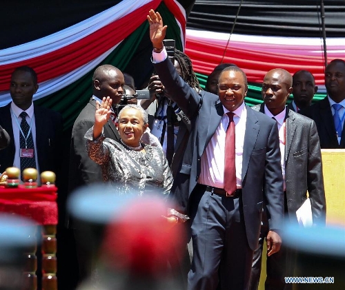 Uhuru Kenyatta (R, front) waves to audience during his inauguration ceremony at Moi International Sports Center in Nairobi, capital of Kenya, April 9, 2013. Kenya's President Uhuru Kenyatta officially took office on Tuesday after being sworn into office as the East African nation's fourth president. (Xinhua/Meng Chenguang)