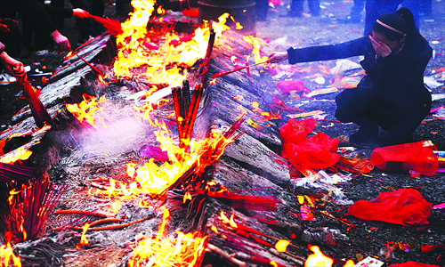 Piles of burning joss sticks left by visitors to Guiyuan Temple in Wuhan. Photos: CFP