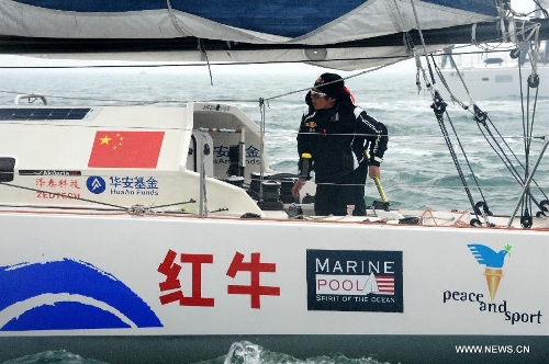 China's Guo Chuan sails toward the shore in Qingdao, east China's Shandong Province, April 5, 2013. Guo sailed back home on Friday morning to become the first Chinese to successfully circumnavigate the globe singlehanded. Aboard his Class40 yacht, 48-year-old Guo travelled about 21,600 nautical miles in 138 days before he returned to his hometown of Qingdao, where he set off on November 18 last year. (Xinhua/Li Ziheng)