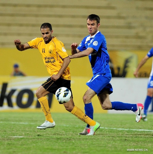 Bader Mutawa (L) of Kuwait's Qadsia SC vies with Rustamov hasan of Tajikistan's Ravshan SC during their AFC Cup football match in Kuwait City, Kuwait, on April 3, 2013. Qadsia won the match 3-0. (Xinhua/Noufal Ibrahim)