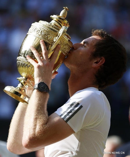 Andy Murray of Britain kisses the trophy during the awarding ceremony for the men's singles event on day 13 of the Wimbledon Lawn Tennis Championships at the All England Lawn Tennis and Croquet Club in London, Britain, July 7, 2013. Andy Murray on Sunday won his first Wimbledon title and ended Britain's 77-year waiting for a men's champion with a 6-4 7-5 6-4 victory over world number one Novak Djokovic. (Xinhua/Wang Lili)