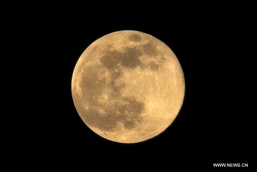 A full moon is seen in Kunming, capital of southwest China's Yunnan Province, June 23, 2013. The moon looks 14 percent larger and 30 percent brighter than usual on Sunday. The scientific term for the phenomenon is 