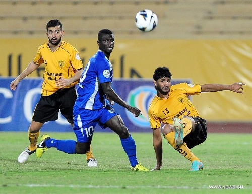 Mesad Nada (R) of Kuwait's Qadsia SC vies with Solaman Takyi (C) of Tajikistan's Ravshan SC during their AFC Cup football match in Kuwait City, Kuwait, on April 3, 2013. Qadsia won the match 3-0. (Xinhua/Noufal Ibrahim) 