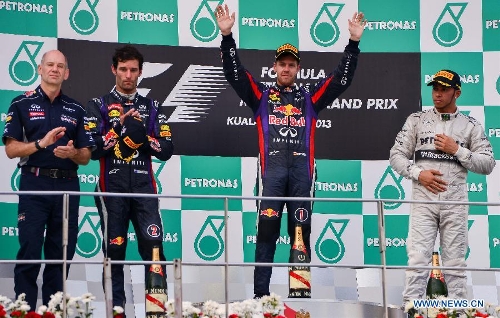 Red Bull driver Sebastian Vettel of Germany (R2) poses on the podium with teammate Mark Webber (L2) of Australia and Mercedes' Lewis Hamilton (R1) of Britain after the Malaysian F1 Grand Prix at Sepang International Circuit outside Kuala Lumpur, Malaysia, March 24, 2013. (Xinhua/Chong Voon Chung)  