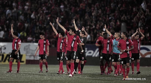 Players of Tijuana's Xolos greet their supporters after a Liga MX soccer match against Chivas in Tijuana, Mexico, on May 3, 2013. (Xinhua/Guillermo Arias) 