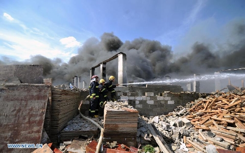 Firemen spray water to control a fire at a warehouse near the Changsha South Railway Station in Changsha, capital of central China's Hunan Province, July 2, 2013. A fire engulfed the warehouse Sunday without injuring anyone. Local fire department took more than two hours to douse the fire. (Xinhua/Li Ga) 