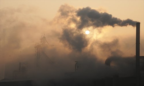 The brownish yellow smoke belched from a chimney at a cement maker in Binzhou, Shandong Province, covers the sky Thursday. Photo: CFP