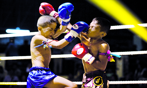 Young Muay Thai boxers fight in the ring at a boxing stadium in Buriram Province in the northeastern region of Isan, about 410 kilometers northeast of Bangkok, on June 28, 2012. Photo: IC