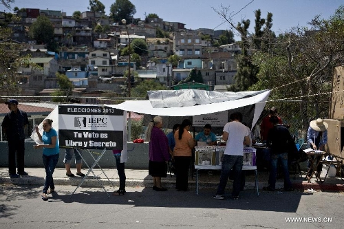 Citizens cast their votes during the election day in the Lomas Taurinas suburb in Tijuana, Baja California, Mexico, on July 7, 2013. On Sunday, elections took place in Mexico's 14 states, where state legislatures and mayorships would be renewed. (Xinhua/Guillermo Arias) 