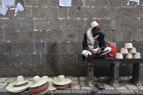 A vendor waits for customers on a street in the Old City of Sanaa, Yemen, on March 24, 2013. According to local media, Yemen's tourism sector suffered losses estimated at one billion U.S. dollars following the 2011 crisis. Vendors in the Old City of Sanaa, a UNESCO World Heritage Site, said the number of foreign tourists declined by at least 90 percent due to the 2011 unrest that severely undermines security in Yemen. (Xinhua/Mohammed Mohammed) 