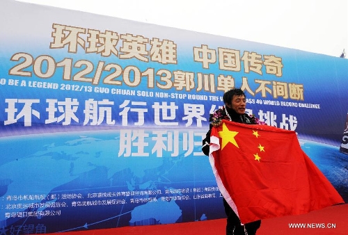 China's Guo Chuan celebrates after returning home in Qingdao, east China's Shandong Province, April 5, 2013. Guo sailed back home on Friday morning to become the first Chinese to successfully circumnavigate the globe singlehanded. Aboard his Class40 yacht, 48-year-old Guo travelled about 21,600 nautical miles in 138 days before he returned to his hometown of Qingdao, where he set off on November 18 last year. (Xinhua/Li Ziheng)