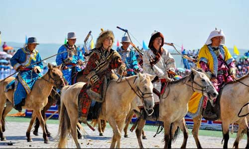 People perform during the opening of a Nadam fair in West Ujimqin Banner, north China's Inner Mongolia Autonomous Region, July 16, 2012. Nadam, meaning entertainment and playing in Mongolian language, is a folk festival of the Mongolian ethnic group. During the event, local residents participate in activities like horse racing, archery and Mongolian wrestling. Photo: Xinhua