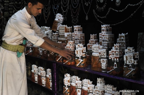 A vendor clean souvenirs while waiting for customers on a street in the Old City of Sanaa, Yemen, on March 24, 2013. According to local media, Yemen's tourism sector suffered losses estimated at one billion U.S. dollars following the 2011 crisis. Vendors in the Old City of Sanaa, a UNESCO World Heritage Site, said the number of foreign tourists declined by at least 90 percent due to the 2011 unrest that severely undermines security in Yemen. (Xinhua/Mohammed Mohammed) 