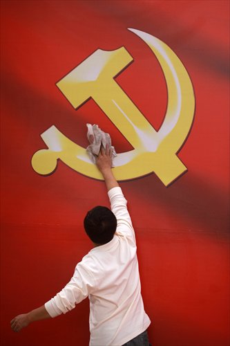 A man cleans the emblem of Communist Party of China in a museum in Haikou, Hainan Province in November 2012. Photo: IC