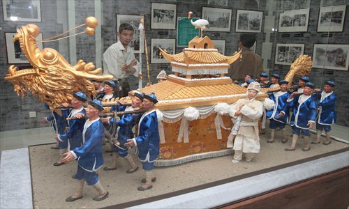 A Shanghai Funeral Museum exhibit illustrates a traditional Chinese funeral with a casket carried by 16 pallbearers. Photo:CFP