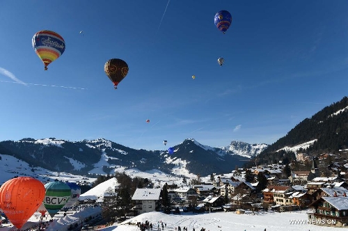 Balloons take off at the 35th International Ballon Festival in Chateau-d'Oex, Switzerland, Jan. 26, 2013. The 9-day ballon festival kicked off here on Saturday with the participation of over 80 balloons from 15 countries and regions. (Xinhua/Wang Siwei) 