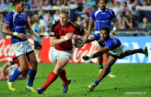 John Moonlight (L2) of Canada vies with Sani Niue of Samoa during a match at the Hong Kong Sevens rugby tournament in south China's Hong Kong, March 24, 2013. Samoa won the match 12-7 to win the 5th place. (Xinhua/Lo Ping Fai) 