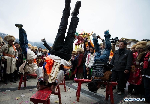 People of the Tibetan ethnic group perform at the Shangjiu Festival in Baoxing County, southwest China's Sichuan Province, Feb. 18, 2013. The residents of Tibetan ethnic group in Baoxing on Monday celebrated the annual Shangjiu Festival, which means the 9th day of Chinese Lunar New Year, to express the respect to the heaven. (Xinhua/Jiang Hongjing)  