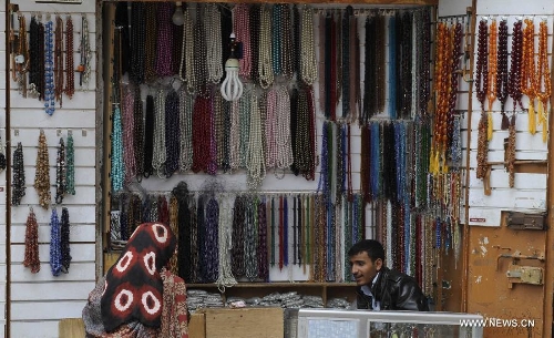 A vendor waits for customers on a street in the Old City of Sanaa, Yemen, on March 24, 2013. According to local media, Yemen's tourism sector suffered losses estimated at one billion U.S. dollars following the 2011 crisis. Vendors in the Old City of Sanaa, a UNESCO World Heritage Site, said the number of foreign tourists declined by at least 90 percent due to the 2011 unrest that severely undermines security in Yemen. (Xinhua/Mohammed Mohammed) 