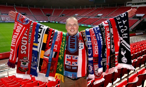 This photo made public by British media on Monday shows Ian Holmes, a soccer-mad Briton, posing with scarves of many different teams at the Stadium of Light in England. Ian has collected about 700 unique team scarves from across the world. He insists on only collecting a scarf for teams he has seen play in person - racking up thousands of pounds in travel each year to grow his crazy collection, which is the biggest in the UK. Photo: IC