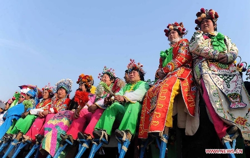  Performers of a local art troupe prepare to perform stilts dance during a festive activity or 