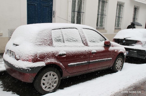   Photo taken on March 12, 2013 shows snow-covered cars on the street of Paris, capital of France. According to Meteo France, the country's weather agency, two departments were put under red alert and 27 others including Paris and suburbs under orange alert on predicted heavy snowfall till Wedenesday morning. (Xinhua/Zheng Bin) 