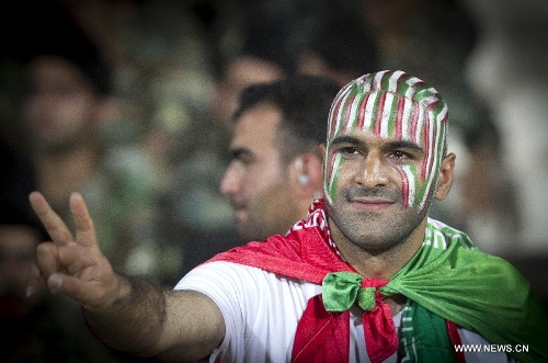 A supporter of Iran makes a victory sign during the 2014 World Cup Qualification Asia match against Lebanon at Azadi stadium in Tehran, Iran, June 11, 2013. Iran won 4-0. (Xinhua/Ahmad Halabisaz) 