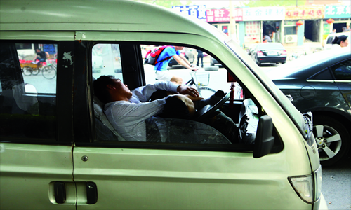 Above: without air conditioning, cars are pretty stuffy. No surprise then that this guy is exhausted. 
Right: tired or just taking advantage of air conditioning and a comfy sofa? A typical scene in IKEA. 1
