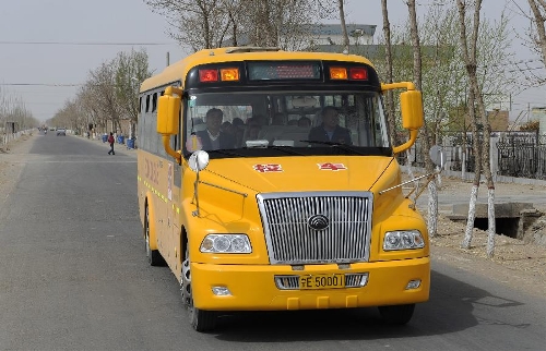 A school bus runs on the rural road in Zhongwei City, northwest China's Ningxia Hui Autonomous Region, March 29, 2013. (Xinhua/Li Ran) 