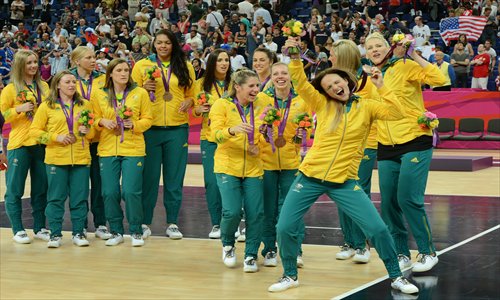 Australian athletes celebrate winning the women's basketball bronze medal at the London Olympic Games on August 11. Photo: AFP