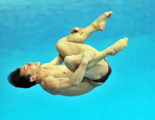 He Chong of China competes during the men's 3m springboard final at the FINA Diving World Series 2013 held at the Aquatics Center, in Beijing, capital of China, on March 16, 2013. He Chong took the 2nd place with 521.50 points. (Xinhua/Li Wen)