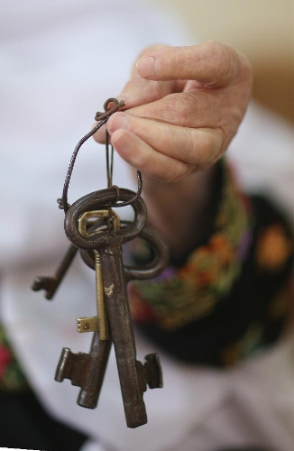 Abu Hafez, a 68-year-old Palestinian, holds the keys of the former house displaced since 1948, in Al-Jalazoun Refugee camp near Ramallah in the West Bank on May 14, 2013. Palestinians are preparing for Nakba Day on May 15, marking thousands of Palestinians that were forced to leave their homes during the Arab-Israeli war in 1948. (Xinhua/Fadi Arouri) 