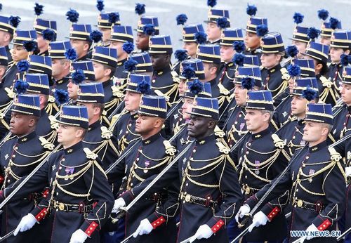 French soldiers attend the annual Bastille Day military parade in Paris, France, July 14, 2012. Under grey sky of a windy day, French President Francois Hollande celebrated his first-ever National Day (known outside of France as Bastille Day) as head of state on Saturday with usual pomp, military parade and flight show. Photo: Xinhua