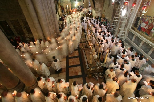 Members of the Catholic clergy hold candles as they take part in a procession at the Catholic Washing of the Feet ceremony in the Church of the Holy Sepulchre in Jerusalem's Old City during Holy Week on March 28, 2013. Holy Week is celebrated in many Christian traditions during the week before Easter. (Xinhua/Muammar Awad) 