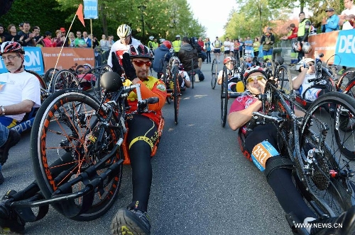 Competitors participate in the Half Marathon Handbike and armchair race during the 9th Geneva Marathon in Geneva, Switzerland, May 5, 2013. Swiss wheelchair athlete Heinz Frei claimed the title with 35:53:03. (Xinhua/Wang Siwei) 