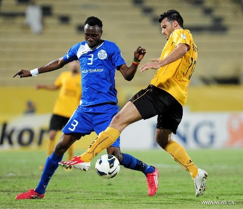 Omar al uma (R) of Kuwait's Qadsia SC vies with Sadik Muah of Tajikistan's Ravshan SC during their AFC Cup football match in Kuwait City, Kuwait, on April 3, 2013. Qadsia won the match 3-0. (Xinhua/Noufal Ibrahim) 