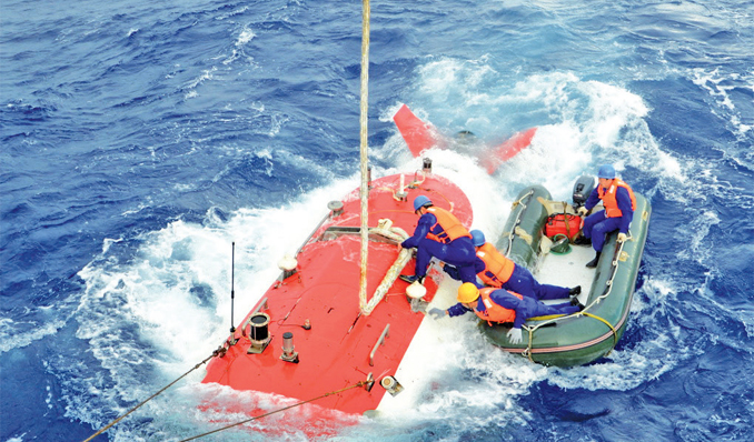 Technicians help dislodge the ropes after the Jiaolong submersible is lowered down from the mother ship before making a dive Tuesday. Photo: CFP