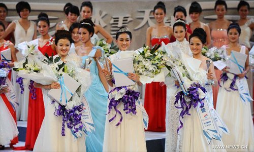 Contestants attend the award ceremony of a beauty contest in Changchun City, capital of northeast China's Jilin Province, Dec. 19, 2012. Photo: Xinhua