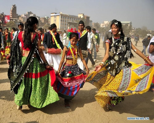 Nepalese Tharu people dressed in traditional clothes join in celebration of the 