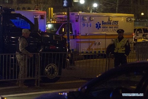 National guardsmen and police stand guard in front of the scene of the explosion in Boston, the United States, April 15, 2013. The two explosions that rocked the Boston Marathon on Monday has killed three people and injured at least 138, officials and media outlets said. (Xinhua/Marcus DiPaola)