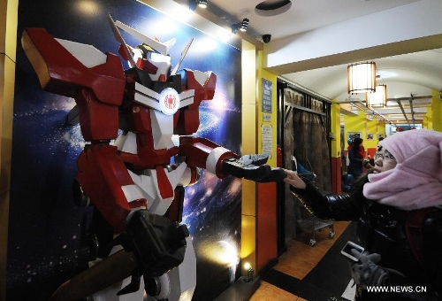 A robot greets customers in a robot themed restaurant in Harbin, capital of northeast China's Heilongjiang Province, Jan. 18, 2013. Opened in June of 2012, the restaurant has gained fame by using a total of 20 robots to cook meals, deliver dishes and greet customers. (Xinhua/Wang Jianwei) 