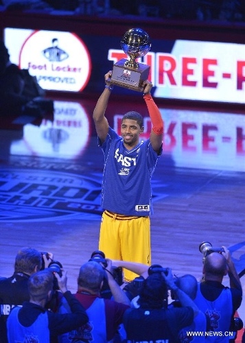Kyrie Irving of Cleveland Cavaliers holds up his trophy after winning the three point contest part of 2013 NBA All-Star Weekend at the Toyota Center in Houston, the United States, Feb. 16, 2013. (Xinhua/Zhang Jun) 