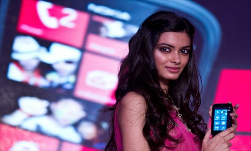 Bollywood film actress Diana Penty poses with the newly unveiled Nokia Lumia 510 smartphone in New Delhi on Tuesday. Nokia unveiled the Windows-powered Lumia 510 entry-level smartphone equipped with a four-inch display, 5-megapixel camera and Nokia maps. Photo: AFP