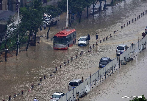 Vehicles wade through a flooded road in Jinjiang City, southeast China's Fujian Province, May 16, 2013. A torrential rainfall hit the city overnight, flooding many roads in the city. (Xinhua) 