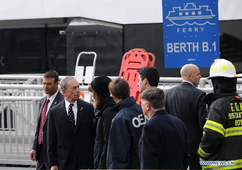  New York Mayor Bloomberg (2nd L) inspects the accident site where a ferry boat crashed into Pier 11 in lower Manhattan, New York, the United States, on Jan. 9, 2013. A high-speed ferry loaded with hundreds of commuters from New Jersey crashed into a dock near Wall Street on Wednesday during the morning rush hour, injuring 57 people. (Xinhua/Shen Hong) 