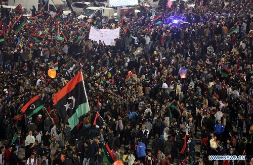 People gather to enjoy the fireworks during a celebration for the second anniversary of the Libyan uprising at the Martyrs' Square in Tripoli on Feb. 17, 2013. (Xinhua/Hamza Turkia) 